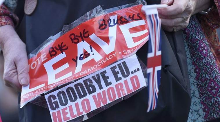 A vote leave supporter holds a poster in Westminster, London, Britain June 24, 2016.       REUTERS/Toby Melville